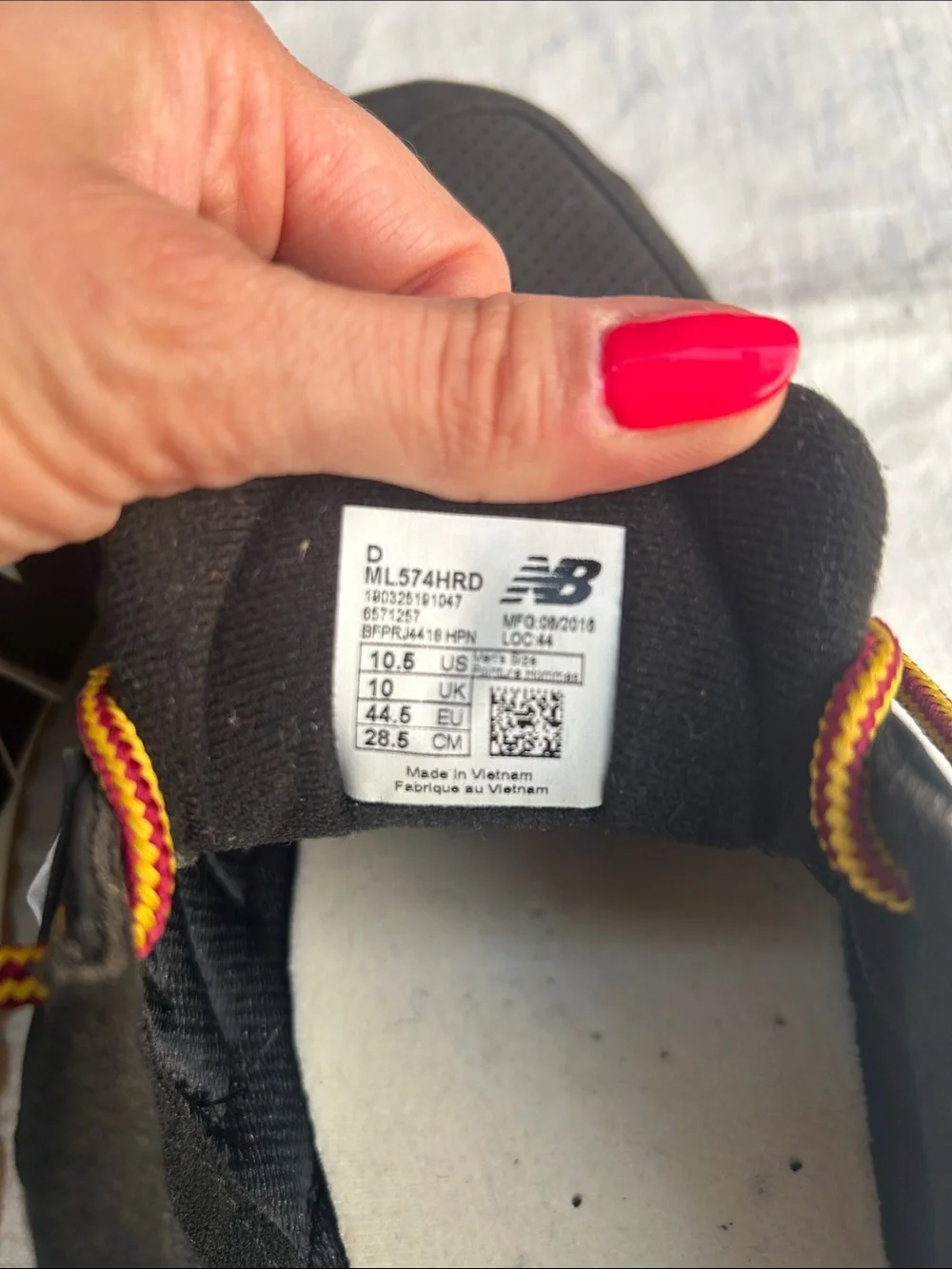 New Balance Men’s Black Sneakers with Tan Sole and Yellow-Orange Laces